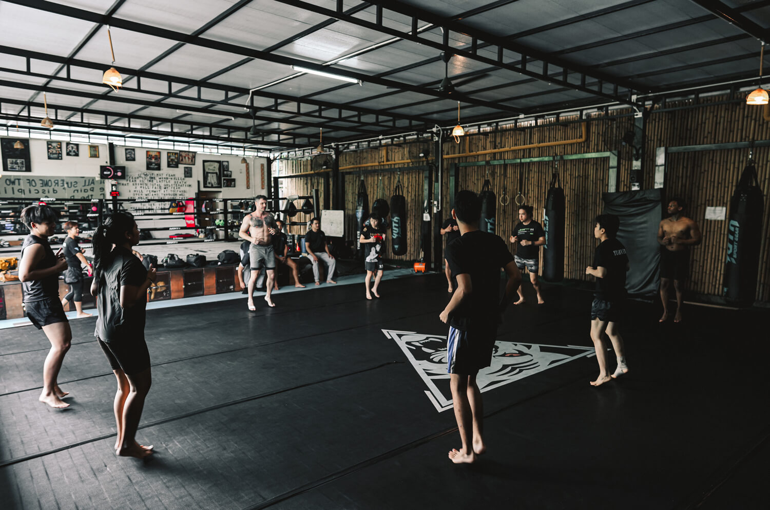 Class warming up in a circle at the start of a session at Tiger Eye