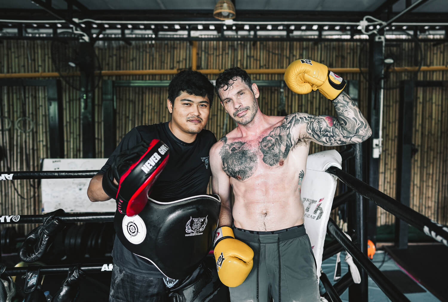 Tiger Eye MMA coach and student in the ring at the gym in Bangkok